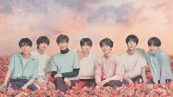 [Image Description: BTS are sitting in a bed of pink, red and yellow flowers. They're all wearing pastel coloured shirts, and there are clouds behind them that are coloured purple and orange. From left to right: J-Hope, V, RM, Jungkook, Jimin, Jin, Suga - Source: Ticketmaster]